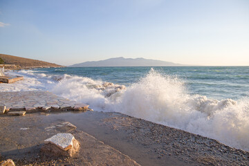 Sea waves breaking on the beach in Crete, Greece at sunset