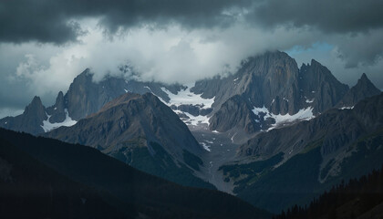 Fototapeta premium Dramatic mountain peaks under stormy clouds, a captivating landscape