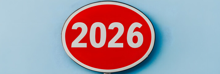 Red sign displaying "2026" in white numerals against a blue background, conveying a sense of direction or time.