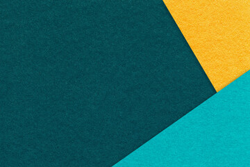 Fototapeta premium Texture craft emerald paper background with yellow and turquoise border. Vintage abstract teal cardboard.