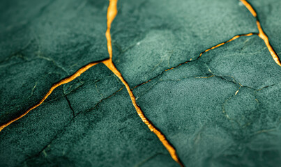 Obraz premium A Stunning Abstract View of Cracked Green Stone with Golden Veins, Ideal for Modern Design and Nature Enthusiasts, Capturing the Essence of Earth's Natural Beauty.