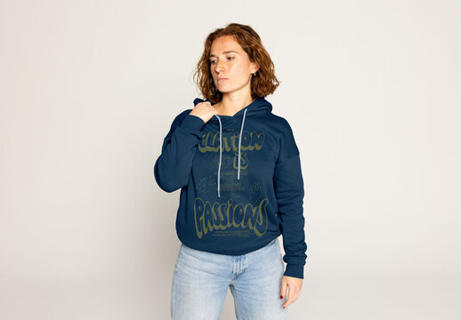 Redhead Woman in a Hoodie Sweater Against a Light Background