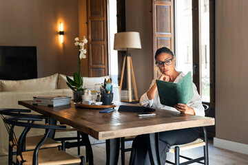 Businesswoman reading notes in her elegant home office