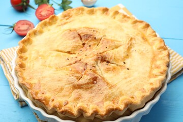 Tasty homemade pie on light blue wooden table, closeup