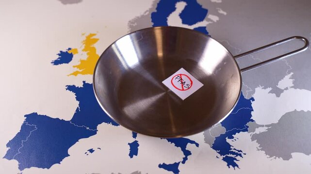 Stainless steel frying pan with pfas free label over european union map