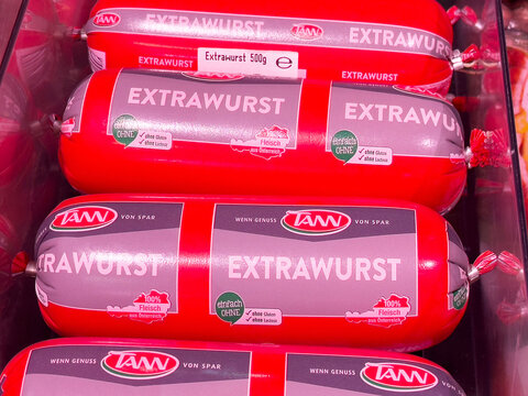 Packaged extrawurst sausages in red casing on display shelf