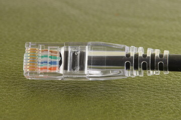 Rj45 Ethernet connector on a colored background. Close-up. 