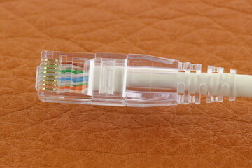 Rj45 Ethernet connector on a colored background. Close-up. 