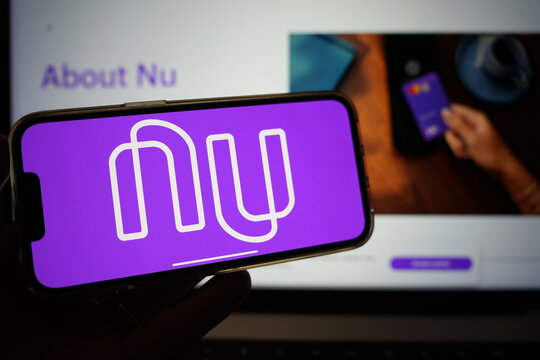 Roosendaal, The Netherlands - February 13, 2025: A mobile phone displaying the logo of NuBank; with the company website in the background.