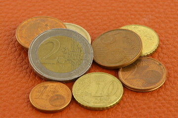 Metal Euro coins on a colored background. 