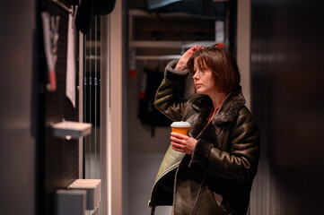 Thoughtful Woman Holding Coffee in a Modern Interior