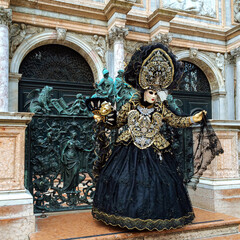Fancy dress and mask at annual Venice Carnival. Venice, Piazza San Marco. An unrecognizable woman...