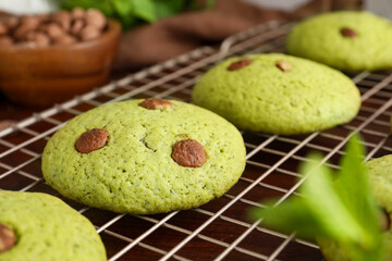 Delicious mint chocolate chip cookies on wooden table, closeup