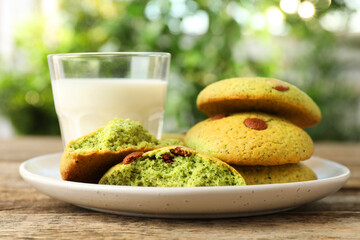 Delicious mint chocolate chip cookies and milk on wooden table