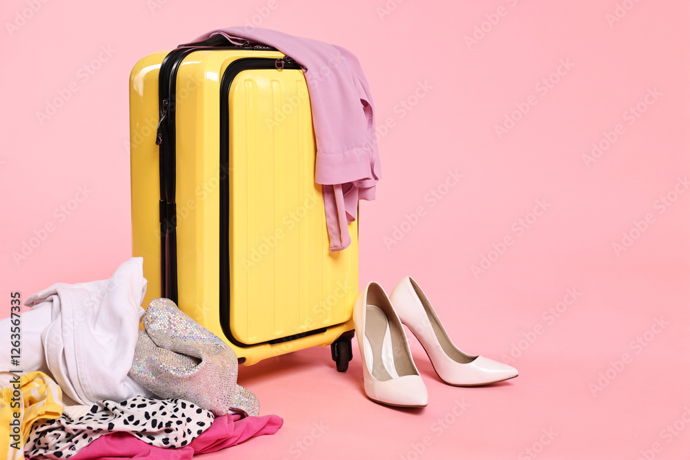 Poster Suitcase, messy clothes and shoes on pink background