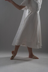 legs of a ballerina in a white dress