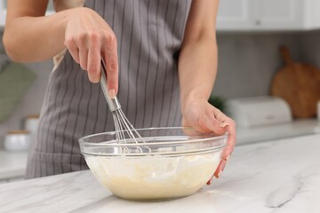 Woman making dough at white marble table indoors, closeup