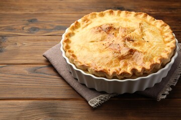 Delicious fresh homemade pie on wooden table, closeup. Space for text