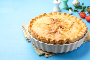 Tasty homemade pie on light blue wooden table, closeup. Space for text