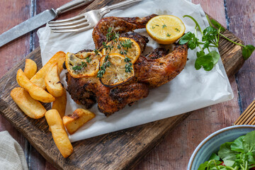 Roasted spatchcock poussin with potato chips
