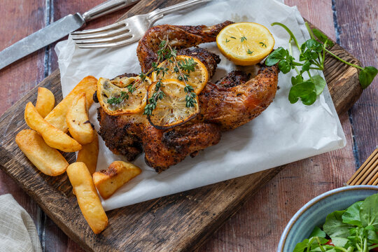 Roasted spatchcock poussin with potato chips