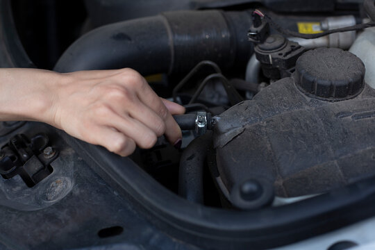 Female hands holding check up car tools