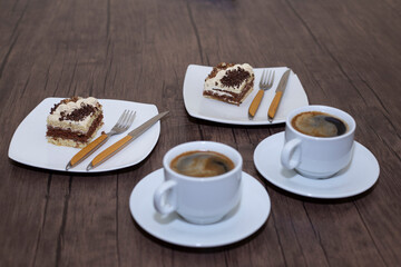 chocolate cake on wooden table with a coffee cup