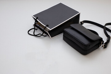 black bag and paper bag on white background