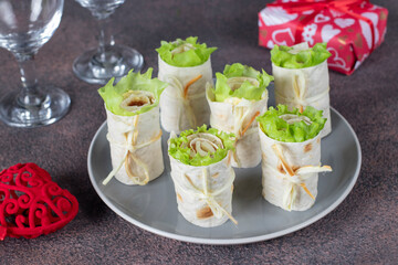 Appetizer from pita bread with ham, cheese and lettuce