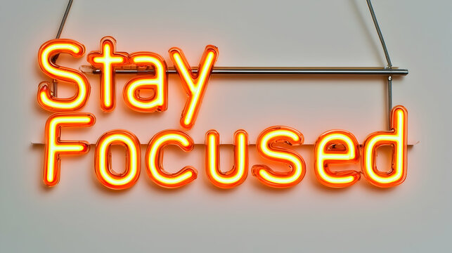 Orange Neon 'Stay Focused' Sign on White Wall, Motivational Message, Modern Interior
