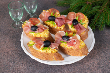 Bruschetta with jamon, egg and cherry tomatoes on white plate