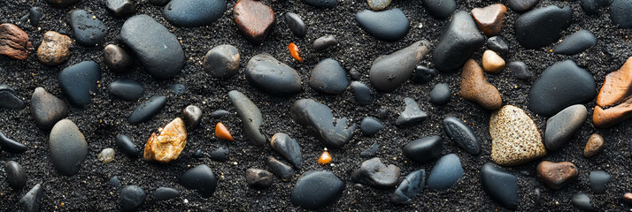 Textured black sand with pebbles shows nature's variety at the beach