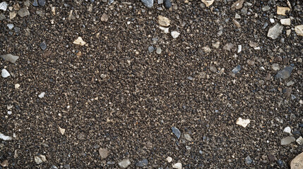 A close-up shot of coarse gravel and crushed stones creating a rough and rugged texture with earthy tones and natural elements  
