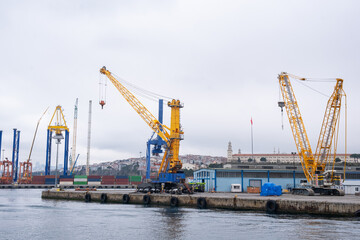 Large industrial port with cranes and cargo ships. Busy shipping port of Haydarpasa and container terminal in Harem Istanbul on sunny day