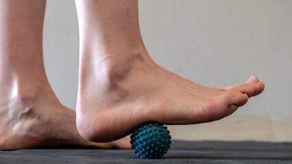 Blue spiky rubber massage ball for recovery massage. MFR ball for rehabilitation and health. Sports...