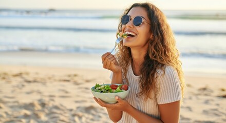 Woman enjoying a fresh salad on the beach, radiating happiness and health