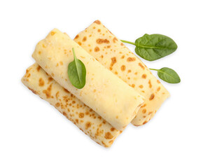 Delicious rolled crepes and basil isolated on white, top view