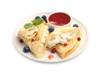 Delicious crepes with cottage cheese, jam, redcurrants and blueberries isolated on white