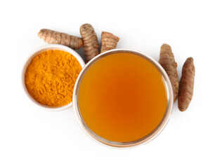 Aromatic turmeric tea in glass, roots and powder isolated on white, top view