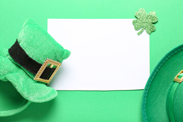 Blank card with leprechaun hats and paper clover on green background. St. Patrick's Day celebration