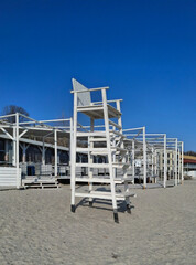 very large chair
huge tall white wooden chair for a lifeguard on the beach