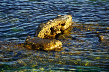 Rocky limestone cliffs that rise from the shallow sea