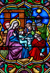 Fototapeta premium Stained glass (19th century) of Christmas Nativity Scene : Adoration of the Magi as they present gifts of gold, frankincense and myrrh to the Infant Jesus. .