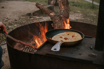 Cooking over fire while camping