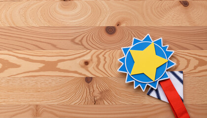Geometric worker's badge honoring achievements on wooden surface, recognition