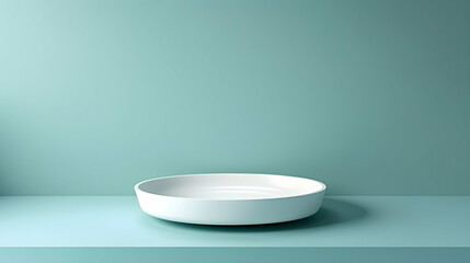 Minimalist white plate on a serene teal background, highlighting simplicity and elegance