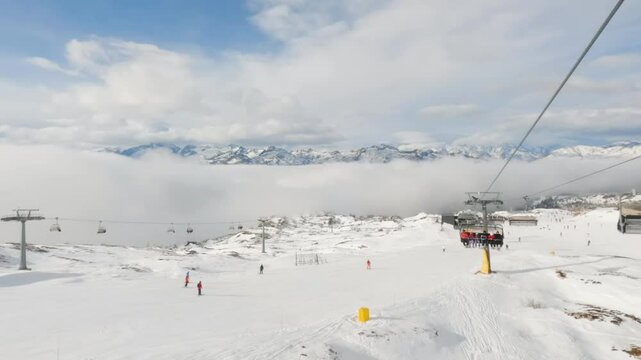 View from chair lift in Madonna di Campiglio ski resort above the clouds