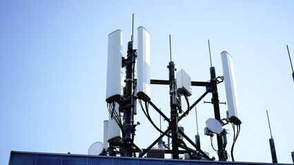 Telecommunication towers on a rooftop transmitting data signals. Vital infrastructure powering modern wireless communication, enabling fast internet, mobile networks, and seamless connectivity.

