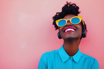 Young call center operator giving a toothy smile while touching a microphone, wearing trendy blue, framed by a pink color background