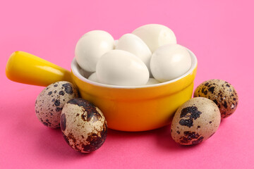 Bowl with fresh boiled quail eggs on pink background